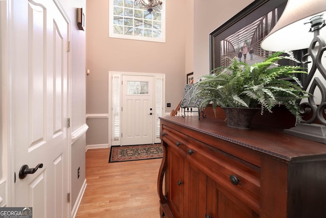 entrance foyer with light wood-type flooring and baseboards