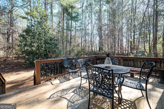 deck with outdoor dining area