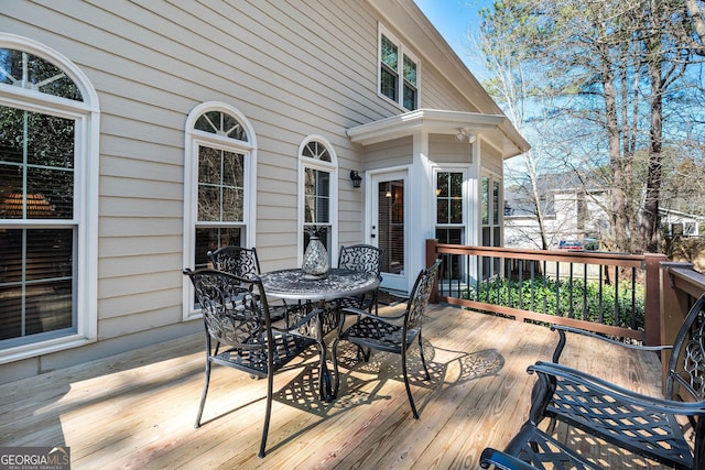 wooden deck with outdoor dining area