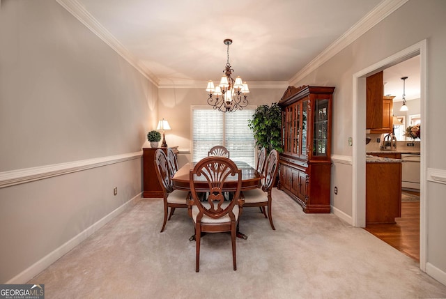 dining area featuring light colored carpet, crown molding, baseboards, and an inviting chandelier