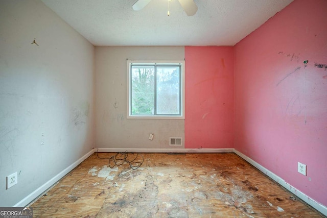 spare room with visible vents, ceiling fan, a textured ceiling, and baseboards