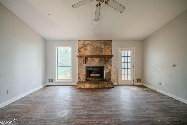 unfurnished living room featuring dark wood-style floors, a fireplace, and visible vents