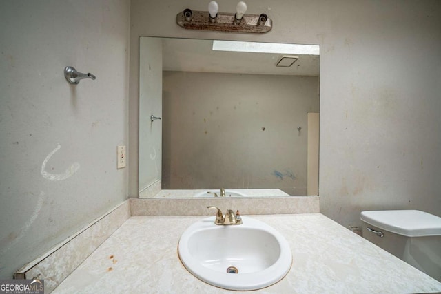 bathroom with vanity and toilet
