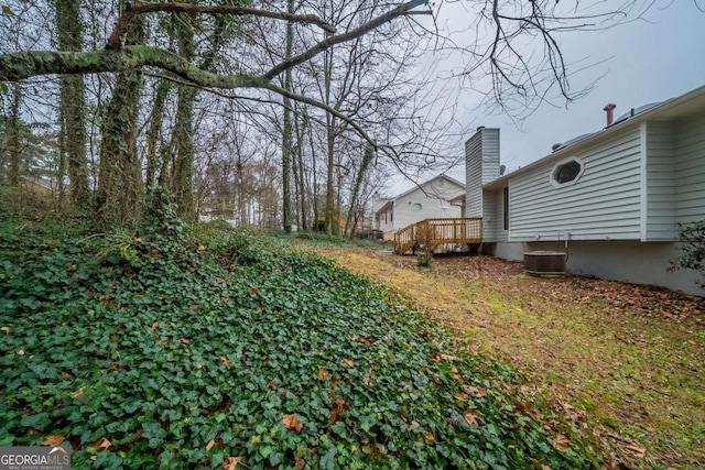view of yard featuring central AC and a wooden deck