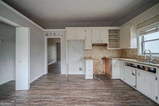 kitchen featuring dark wood-style floors, open shelves, a sink, and white cabinets