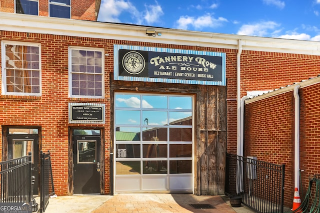 entrance to property featuring brick siding