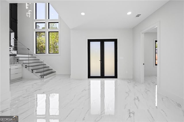 foyer featuring marble tiled floors, recessed lighting, baseboards, and stairway