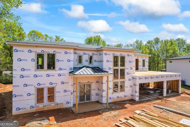 back of property featuring a standing seam roof and metal roof