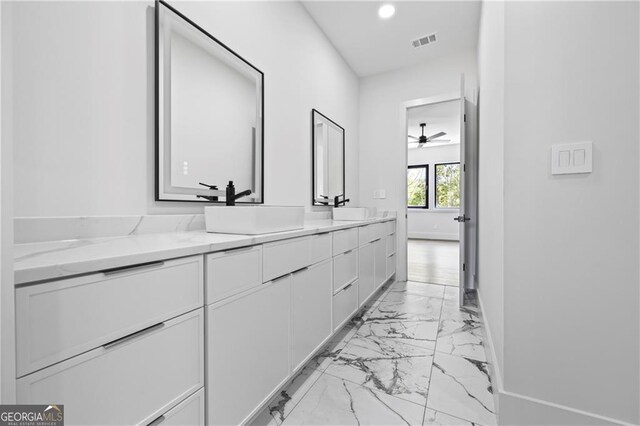 bathroom with marble finish floors, double vanity, recessed lighting, baseboards, and a ceiling fan