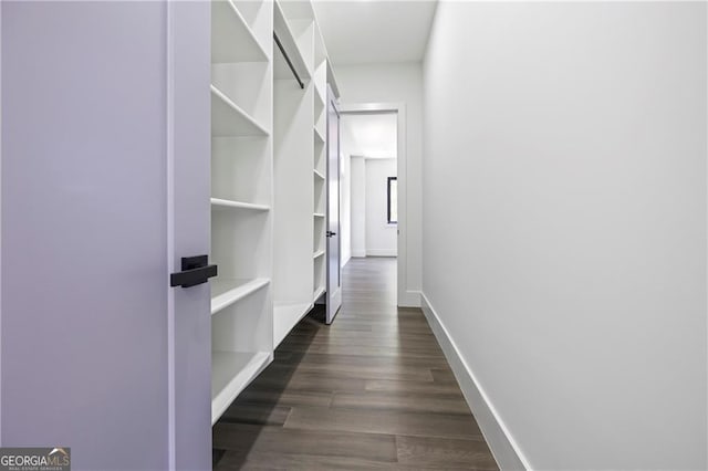 hall with dark wood finished floors and baseboards