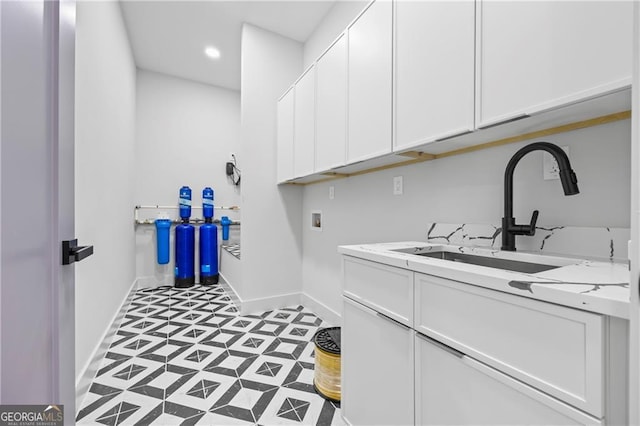laundry area featuring hookup for a washing machine, baseboards, cabinet space, light floors, and recessed lighting