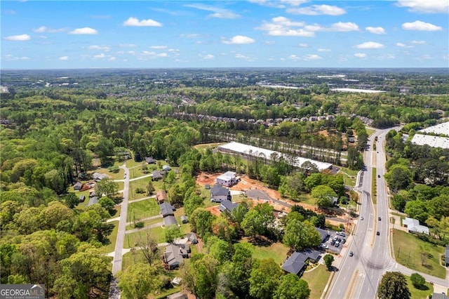 aerial overview of property's location with a highway and a heavily wooded area