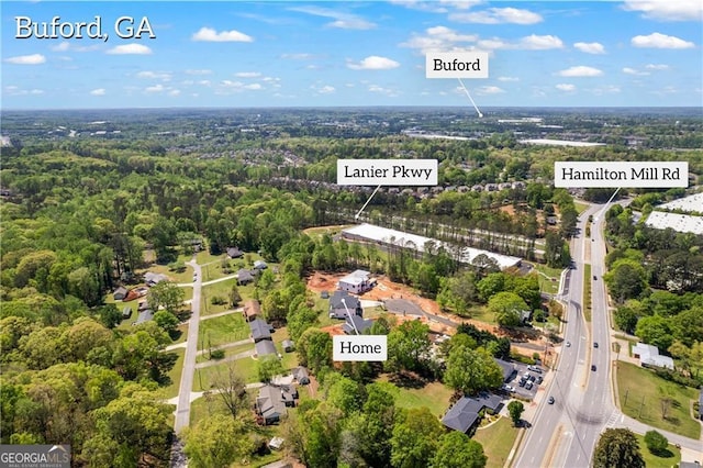 view of property location with a heavily wooded area and a highway