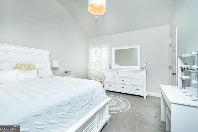 bedroom with lofted ceiling, light carpet, and baseboards