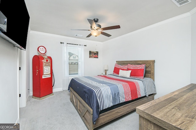 bedroom with ornamental molding, visible vents, light carpet, and a ceiling fan