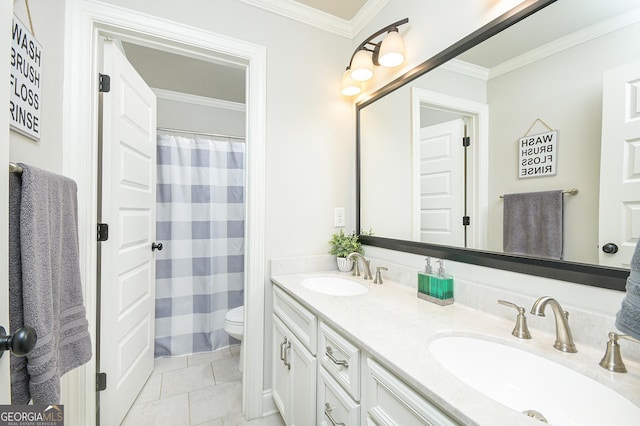 bathroom with toilet, double vanity, ornamental molding, and a sink