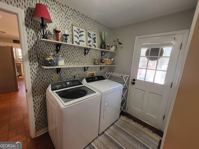 washroom with laundry area, independent washer and dryer, and wallpapered walls