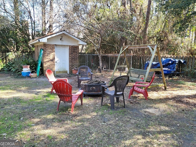 view of yard featuring fence and a fire pit