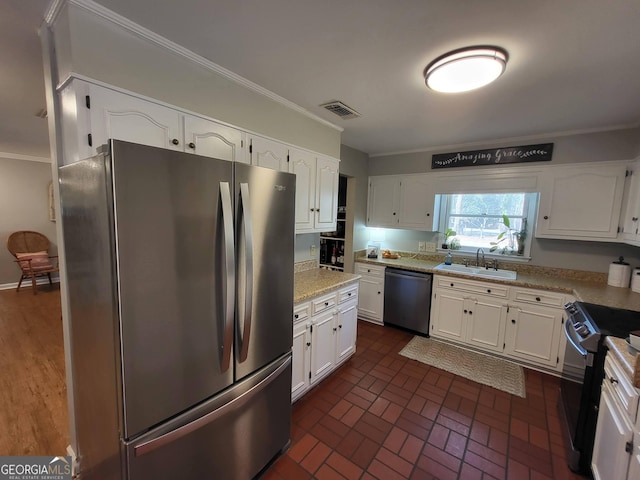 kitchen with white cabinetry, stainless steel appliances, and a sink