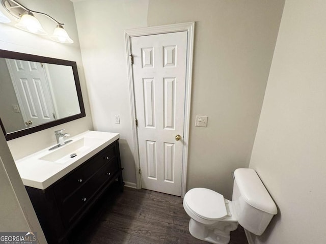 1004 Hamilton Dr, Locust Grove, GA 30248 - bathroom featuring toilet, wood finished floors, and vanity