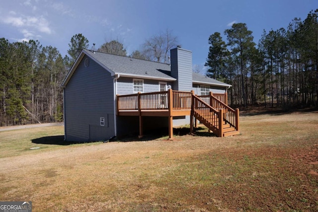 1004 Hamilton Dr, Locust Grove, GA 30248 - back of property featuring stairs, a chimney, a lawn, and a wooden deck