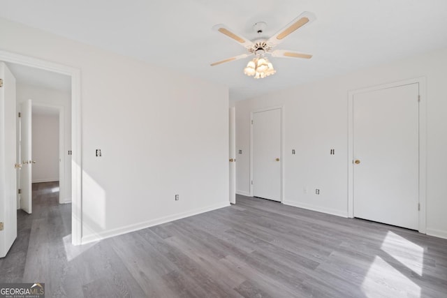 unfurnished bedroom featuring baseboards, ceiling fan, and light wood finished floors