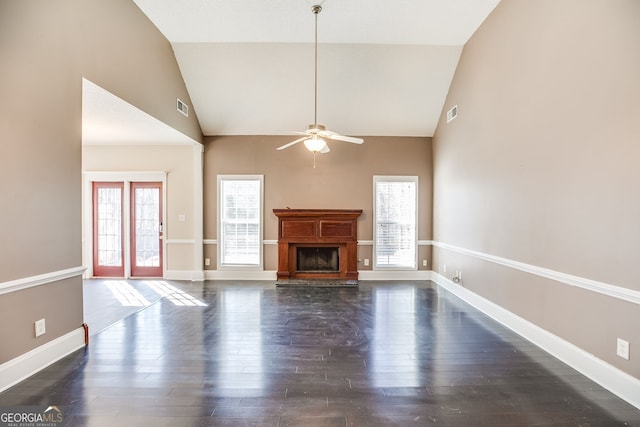 unfurnished living room with dark wood-style floors, a fireplace with raised hearth, visible vents, and baseboards