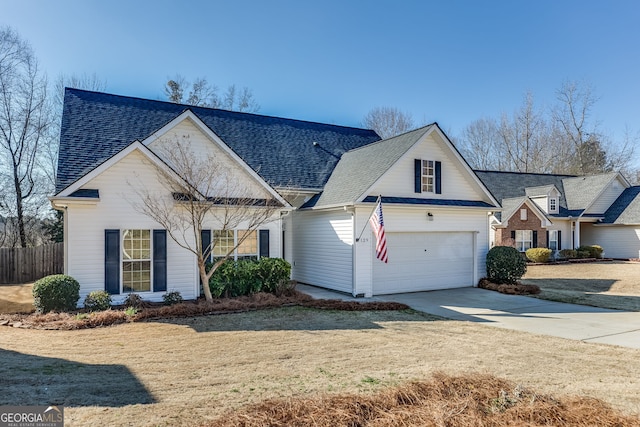 view of front of home featuring a garage, a front yard, concrete driveway, and roof with shingles