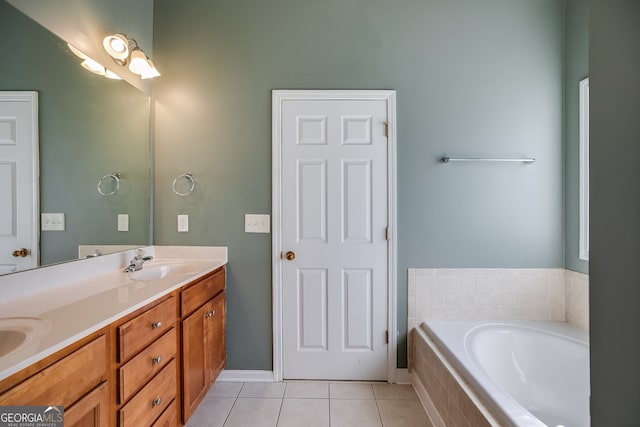 bathroom with a garden tub, double vanity, a sink, and tile patterned floors