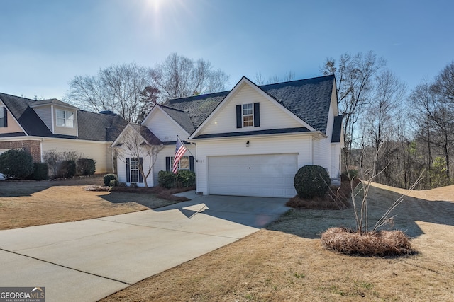 view of front facade with a garage, a shingled roof, concrete driveway, and a front yard