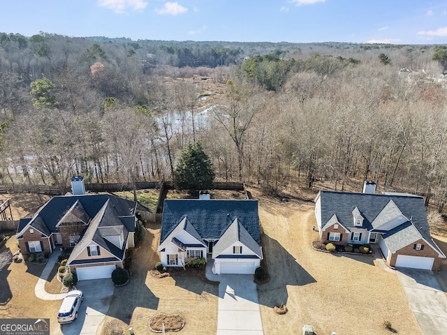 birds eye view of property featuring a view of trees