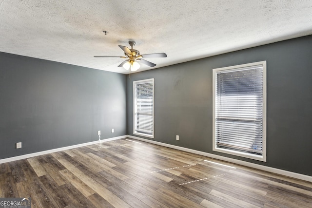 2701 Cumberland Ct SE, Smyrna, GA 30080 - unfurnished room featuring ceiling fan, a textured ceiling, baseboards, and wood finished floors