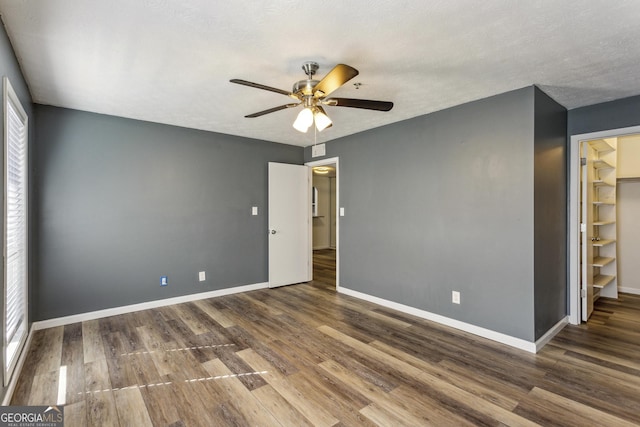 2701 Cumberland Ct SE, Smyrna, GA 30080 - empty room with dark wood-style flooring, ceiling fan, a textured ceiling, and baseboards