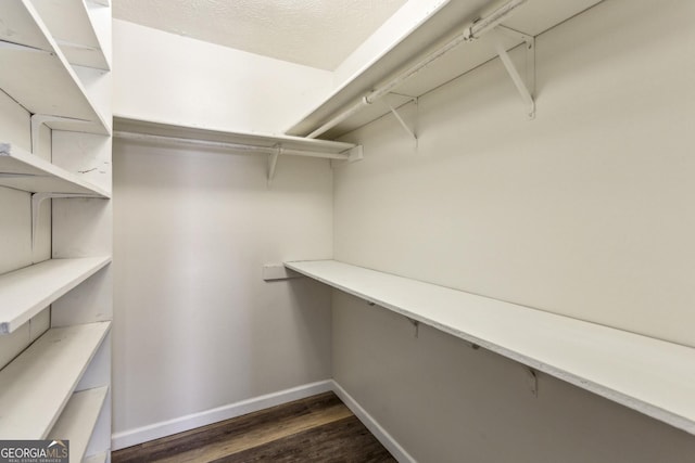 2701 Cumberland Ct SE, Smyrna, GA 30080 - walk in closet with dark wood finished floors