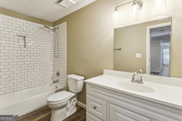2701 Cumberland Ct SE, Smyrna, GA 30080 - bathroom featuring toilet, a textured ceiling, vanity, wood finished floors, and  shower combination