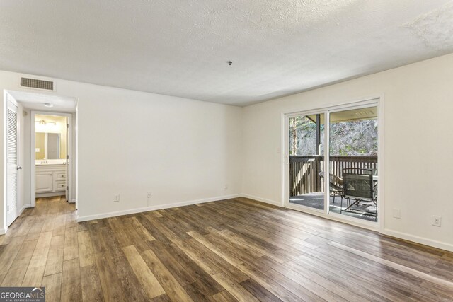 2701 Cumberland Ct SE, Smyrna, GA 30080 - interior space with a textured ceiling, wood finished floors, visible vents, and baseboards