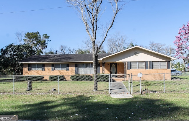 ranch-style house featuring a fenced front yard and brick siding