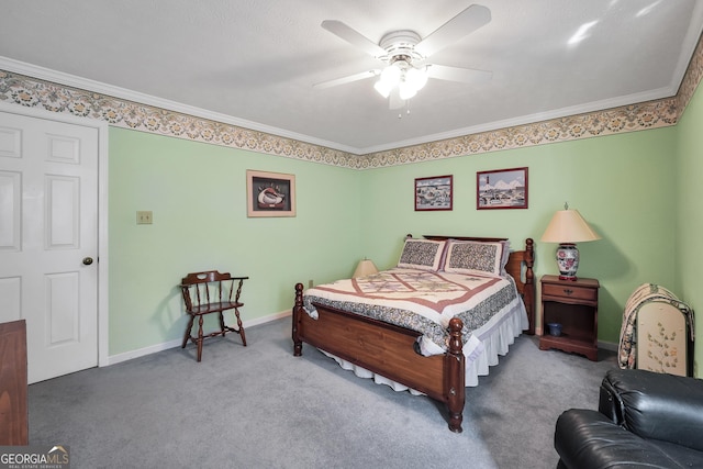 carpeted bedroom featuring a ceiling fan, crown molding, and baseboards