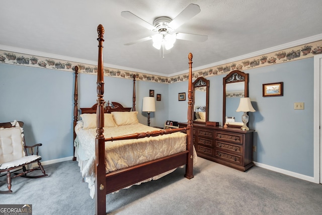 bedroom with a ceiling fan, crown molding, baseboards, and carpet flooring