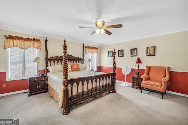 bedroom featuring baseboards, crown molding, and light colored carpet