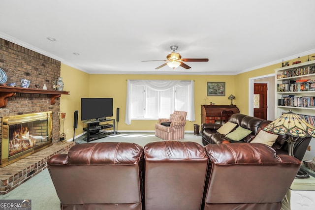 carpeted living room featuring a brick fireplace, baseboards, a ceiling fan, and crown molding