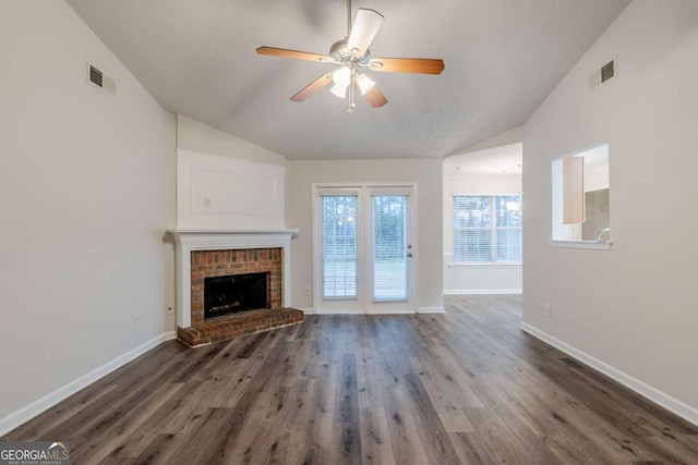 unfurnished living room with vaulted ceiling, wood finished floors, visible vents, and baseboards