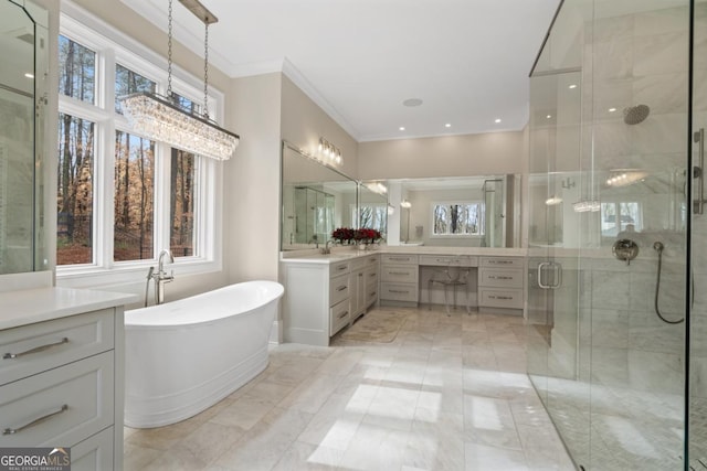 bathroom featuring a freestanding bath, ornamental molding, a shower stall, and vanity