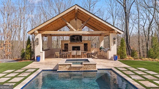 rear view of property featuring a patio area, an outdoor pool, exterior fireplace, and an in ground hot tub