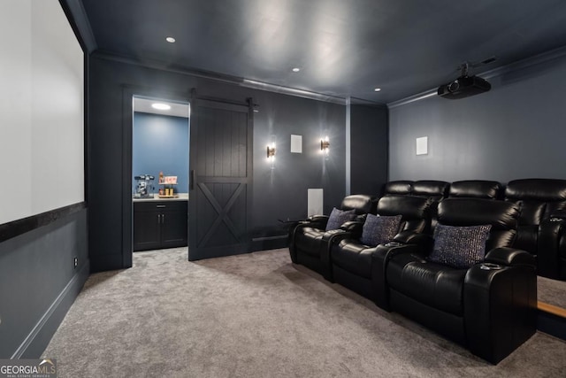 cinema room featuring recessed lighting, light carpet, crown molding, and a barn door