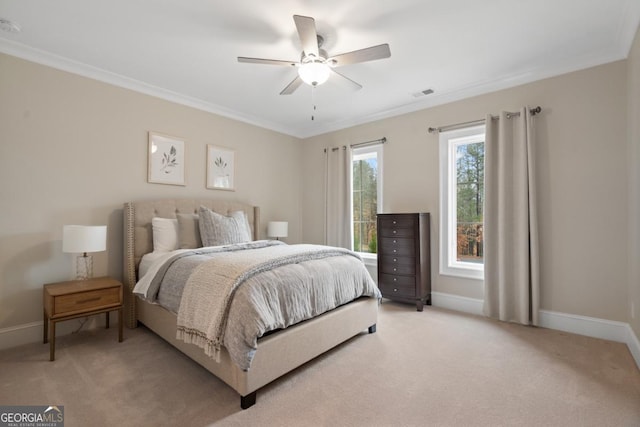 bedroom featuring baseboards, ornamental molding, visible vents, and light colored carpet