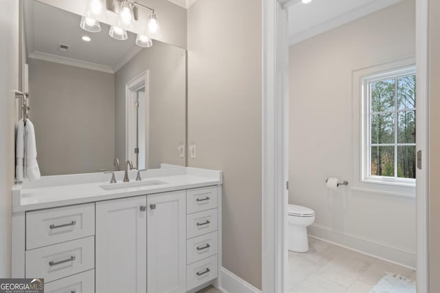 bathroom with toilet, baseboards, crown molding, and vanity