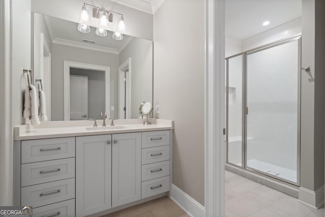 bathroom with vanity, visible vents, baseboards, ornamental molding, and a shower stall