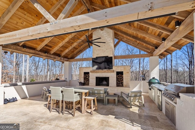 view of patio featuring an outdoor stone fireplace, grilling area, and area for grilling