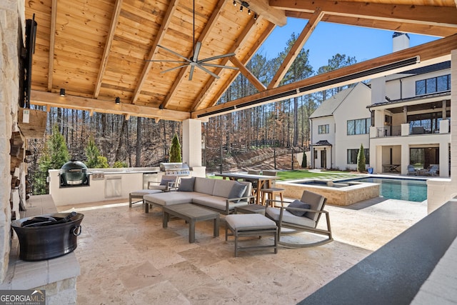 view of patio / terrace featuring grilling area, a ceiling fan, an in ground hot tub, exterior kitchen, and an outdoor pool